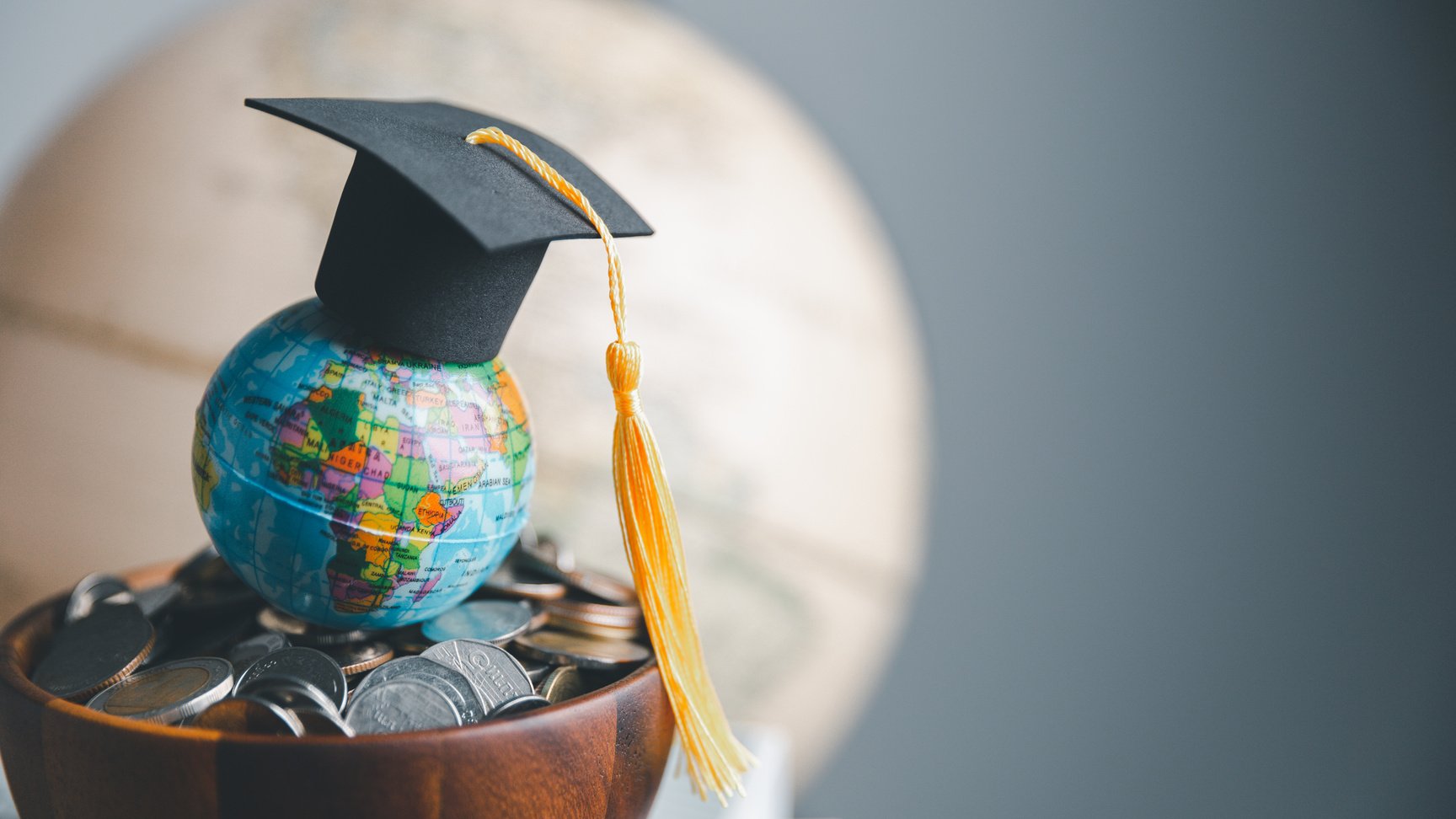 Graduation cap with Earth globe. Concept of global business study, abroad educational, Back to School. Education in Global world, Study abroad business in universities in worldwide. language study